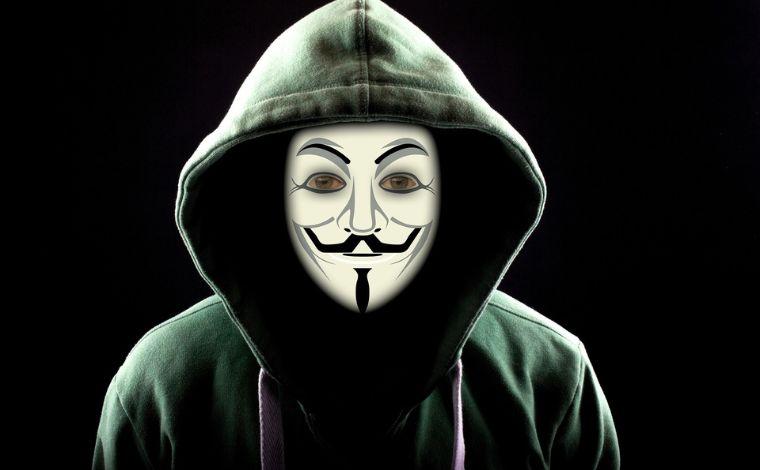 Anonymous person wearing the Guy Fawkes mask mask depicting a pale face with a...